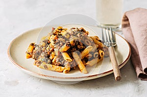 Tomato sauce ground beef pasta on a white stone background. Tone