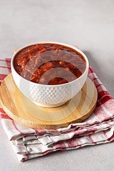 Tomato Sauce or Homemade Ketchup Healthy Vegetable Sauce in White Bowl on Wooden Tray Vertical