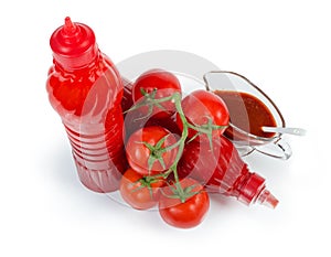 Tomato sauce in plastic bottles, in gravy boat, tomatoes branch