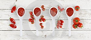 tomato sauce spoon with tomatoes and basil Isolated on wooden white background