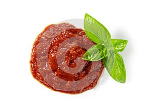 Tomato sauce on a white background with basil on the side