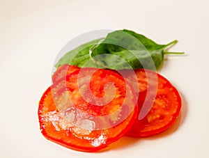 Tomato slices with basilic leaf