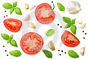 tomato slices with garlic and basil isolated on white background, top view