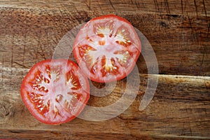 Tomato slices on wooden board