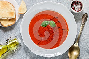 Tomato soup with Basil and spices in a white plate