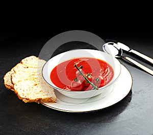 Tomato, soup and bread on menu in restaurant with bowl of healthy food for weight loos diet with nutrition. Dinner, dish