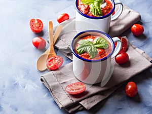 Tomato soup in enamel mugs