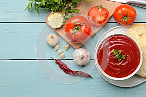 Tomato soup and ingredients for cooking, tomatoes and garlic, oil and spices. top view