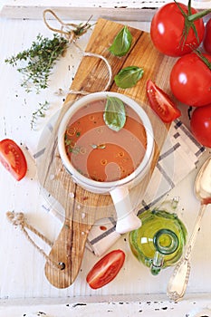 Tomato soup, olive oil, thyme and bunch of ripe tomatoes