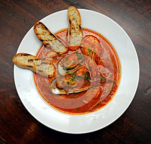 Tomato soup with seafood and toasts