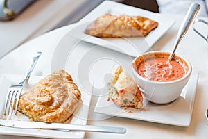 Tomato soup with spoon and bread