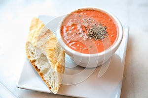 Tomato soup with spoon and bread