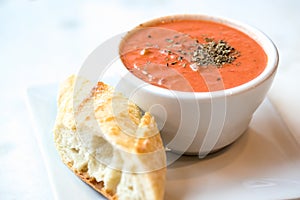 Tomato soup with spoon and bread