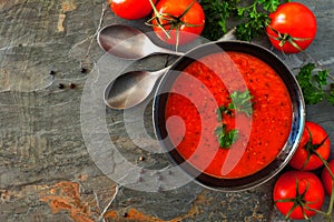 Tomato soup, top view corner border on a slate background