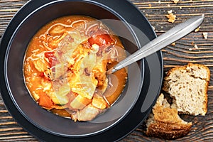Tomato soup with vegetables and meat, tasty, appetizing traditional Ukrainian borsch, close-up, top view, shallow depth