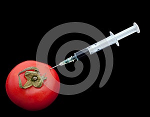 Tomato and syringe - food safety concept