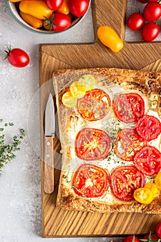 Tomato tart, puff pastry topped with cream cheese or ricotta and tomatoes.