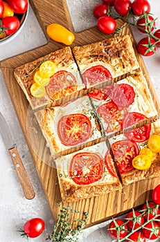 Tomato tart, puff pastry topped with cream cheese or ricotta and tomatoes.