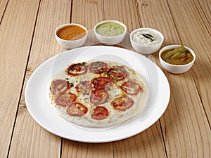 Tomato uthappam with sambar and chutneys an traditional South Indian food