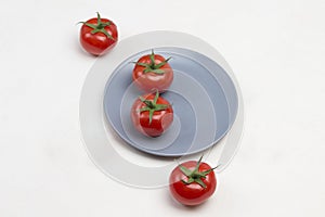 Tomatoes and allspice on gray plate