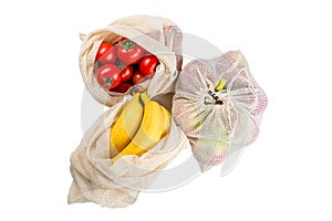 tomatoes, banana and apples in eco friendly mesh bags isolated, zero waste