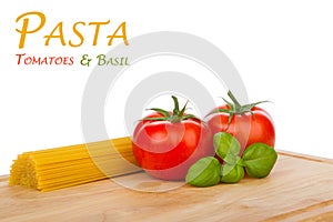 Tomatoes, basil and uncooked spaghetti