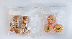 Tomatoes and Champignon Mushroom in food preservation plastic bag, on white background