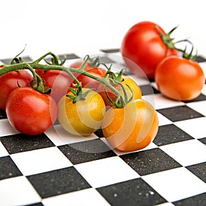 Tomatoes on checkered table on transparent background