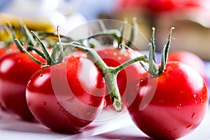 Tomatoes. Cherry tomatoes. Cocktail tomatoes. Fresh grape tomatoes carafe with olive oil