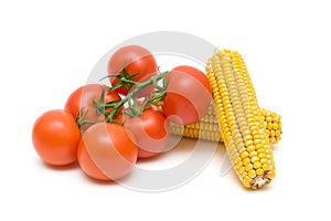 Tomatoes and corn closeup on white background