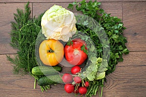 Tomatoes cucumbers cabbage radish dill and parsley on a table in the village