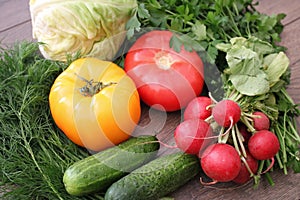 Tomatoes cucumbers cabbage radish dill and parsley on a table in the village