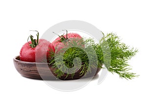 Tomatoes with dill on the plate