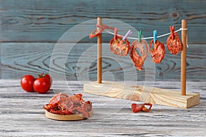 Tomatoes are dried on the table with fresh tomatoes