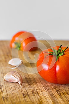 Tomatoes and garlic on a cutting board, shallow depth of field