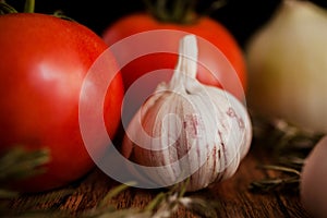 Garlic and tomatoes on a wood background close-up ingredients table top