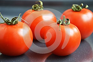 Tomatoes on grey background