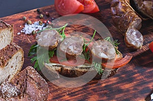 Tomatoes, herbs and bread. Homemade sausage and homemade bread.