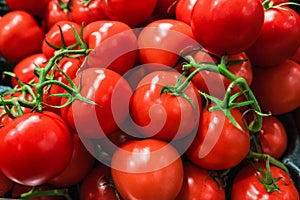 Tomatoes lying on a pile on top of each other, tomato texture. Delicious fresh red tomatoes placed on the market photo