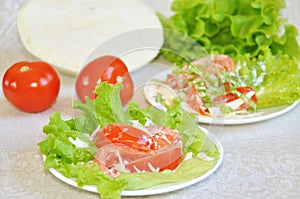 Tomatoes with mayonnaise on lettuce