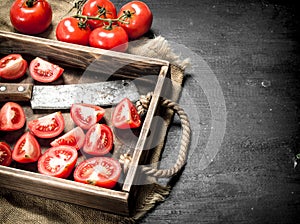 Tomatoes with old hatchet on the tray.