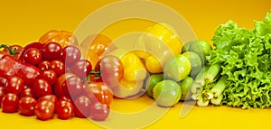 Tomatoes, peppers, celery, limes on yellow background