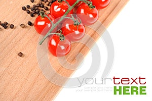 Tomatoes and peppers on wooden board