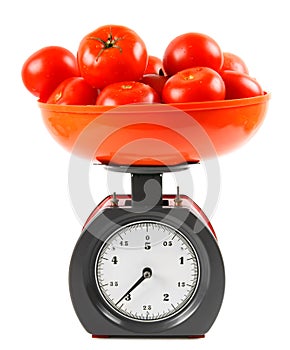 Tomatoes on scales. On white background.