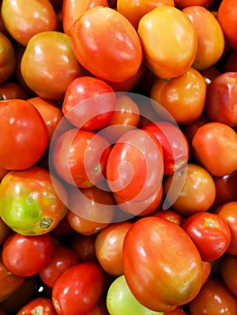 Tomatoes on shelves in supermarket, market