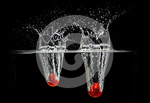 Tomatoes Splash Photography: on a black background