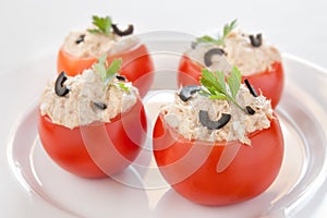 Tomatoes stuffed with tuna and black olives photo