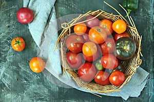 Tomatoes on the table, in a basket, top view, flat ley, harvest concept,