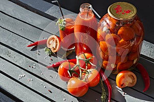 tomatoes, tomato juice in a glass, tomato juice in a bottle, canned tomatoes in a jar, fresh tomatoes ,pepper, mint, rosemary