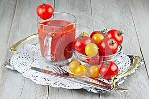 Tomatoes, tomato ketchup and tomato juice with lettuce leaves, isolated on a green background.